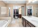 Luxurious bathroom with double vanity, soaking tub, and walk-in shower at 483 Douglas Edward Dr, Ocoee, FL 34761