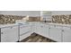 Updated kitchen featuring white cabinets, quartz countertops and mosaic backsplash at 842 E Church Ave, Longwood, FL 32750