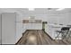 Modern kitchen with white cabinets, new appliances, and stylish backsplash at 842 E Church Ave, Longwood, FL 32750