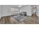 Living room with grey couch and access to kitchen at 842 E Church Ave, Longwood, FL 32750