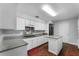 Kitchen with granite countertops, white cabinets, and kitchen island at 119 Edgewater Dr, St Cloud, FL 34769