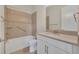Bathroom with tub, toilet, and vanity with tan countertop at 14157 Creekbed Cir, Winter Garden, FL 34787