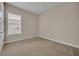 Simple bedroom with carpeted floor and window with blinds at 14157 Creekbed Cir, Winter Garden, FL 34787