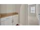 White built-in cabinets with a tan countertop and view of bedroom at 14157 Creekbed Cir, Winter Garden, FL 34787