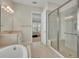 Main bathroom featuring a walk-in shower and separate tub at 14157 Creekbed Cir, Winter Garden, FL 34787