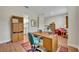 Home office with wood desk, chair, and red armchair at 14157 Creekbed Cir, Winter Garden, FL 34787
