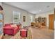 Home office with wood desk, chair, and red armchair at 14157 Creekbed Cir, Winter Garden, FL 34787