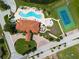 An aerial view of the clubhouse, pool, tennis courts, and meticulously landscaped grounds at 1788 Coriander Dr, Kissimmee, FL 34759