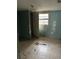 A simple bedroom with light teal walls and tile floor at 3108 Lawrence St, Orlando, FL 32805