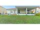 Landscaped backyard showcasing a screened porch and lush lawn at 3151 Riachuelo Ln, Kissimmee, FL 34744