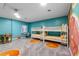 Bedroom with bunk beds, orange accents, and game table at 3151 Riachuelo Ln, Kissimmee, FL 34744
