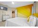Bedroom with yellow accent wall and king bed at 3151 Riachuelo Ln, Kissimmee, FL 34744