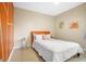 Bedroom with orange accent wall and comfortable bed at 3151 Riachuelo Ln, Kissimmee, FL 34744
