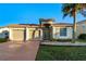 Two-car garage, front yard, and light-colored house at 3151 Riachuelo Ln, Kissimmee, FL 34744