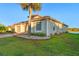 Tan house exterior with a two-car garage and landscaping at 3151 Riachuelo Ln, Kissimmee, FL 34744