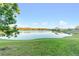 Stunning view of a peaceful lake with lush green landscaping at 3151 Riachuelo Ln, Kissimmee, FL 34744