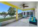 Relaxing screened porch overlooking a lake, featuring comfortable seating and a ceiling fan at 3151 Riachuelo Ln, Kissimmee, FL 34744