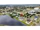 Aerial view of the real estate property showcasing a lake, neighborhood, landscaping and a pool at 3301 Buckingham Way, St Cloud, FL 34772