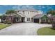 Elegant home with stone accents, lush landscaping, and a spacious driveway at 3301 Buckingham Way, St Cloud, FL 34772