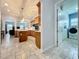 Open kitchen layout with island, wooden cabinets, and stainless steel appliances at 3301 Buckingham Way, St Cloud, FL 34772