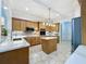 Bright kitchen with wood cabinets, stainless appliances, island, and tile flooring at 3301 Buckingham Way, St Cloud, FL 34772