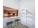 Kitchen pass-through with barstool seating and views of the modern, updated kitchen at 3301 Buckingham Way, St Cloud, FL 34772
