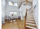 Bright living room with high ceilings, hardwood floors, and a staircase at 3301 Buckingham Way, St Cloud, FL 34772