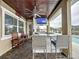 Inviting outdoor bar area with barstool seating and a view of the pool and lake at 3301 Buckingham Way, St Cloud, FL 34772