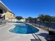 Inviting backyard pool with comfortable seating and a view of the serene lake at 3301 Buckingham Way, St Cloud, FL 34772