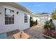 Charming courtyard features brick pavers, white stucco walls, manicured landscaping, and outdoor seating at 4459 Twinview Ln, Orlando, FL 32814