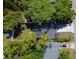An aerial view of a home with a dark roof, well-maintained yard, and mature trees at 5255 Seminole Ave, Winter Park, FL 32792