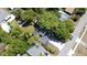 Aerial view featuring a home with a dark roof, mature trees and a community pool nearby at 5255 Seminole Ave, Winter Park, FL 32792