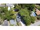 Aerial view of a home with a dark roof, mature trees and a community pool nearby at 5255 Seminole Ave, Winter Park, FL 32792