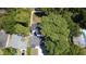 Aerial view of home featuring a dark roof, mature trees and an ample driveway at 5255 Seminole Ave, Winter Park, FL 32792