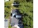 Aerial view showcases a home with a dark roof and mature trees, in a sunny setting at 5255 Seminole Ave, Winter Park, FL 32792