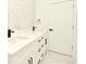 Modern bathroom with double vanity, black fixtures, and bright lighting at 5255 Seminole Ave, Winter Park, FL 32792