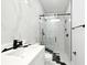 Modern bathroom featuring a marble tiled wall, black shower, vanity and fixtures at 5255 Seminole Ave, Winter Park, FL 32792