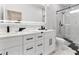 Modern bathroom features a double vanity, sleek fixtures, and a glass shower at 5255 Seminole Ave, Winter Park, FL 32792
