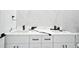 Modern bathroom featuring double sink vanity with black fixtures and stylish white and black marble countertop and backsplash at 5255 Seminole Ave, Winter Park, FL 32792