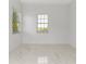 Sunlit bedroom with tile flooring; a minimalist design and bright space at 5255 Seminole Ave, Winter Park, FL 32792