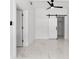 Bright bedroom showcasing a sliding barn door to the closet, large windows, and sleek marble flooring at 5255 Seminole Ave, Winter Park, FL 32792