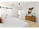 Bright bedroom features a barn door closet and stylish dresser at 5255 Seminole Ave, Winter Park, FL 32792