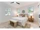 Serene bedroom with a neutral palette, large windows, and a stylish bench at 5255 Seminole Ave, Winter Park, FL 32792