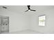 Bright, white bedroom with recessed lighting, a ceiling fan, and an en suite bathroom with a marble floor at 5255 Seminole Ave, Winter Park, FL 32792