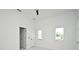 Bright bedroom featuring a ceiling fan, two windows, and two doors, complete with stylish marble-like floors at 5255 Seminole Ave, Winter Park, FL 32792