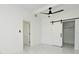 Bright bedroom featuring modern fixtures, sleek white walls and a sliding door closet at 5255 Seminole Ave, Winter Park, FL 32792