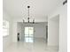 Open-concept dining area with modern chandelier, flowing into living spaces at 5255 Seminole Ave, Winter Park, FL 32792