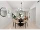 Elegant dining room featuring modern chandelier, round table, large mirror, and an open layout at 5255 Seminole Ave, Winter Park, FL 32792