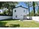 Modern two-story home with a fenced yard, lush greenery, and a charming outdoor patio with a fire pit at 5255 Seminole Ave, Winter Park, FL 32792
