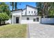 Stunning two-story modern home showcasing a minimalist design with black and white colors and a well-manicured lawn at 5255 Seminole Ave, Winter Park, FL 32792